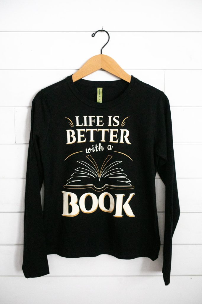 Black shirt with the phrase 'Life is better with a book' and an open book graphic.
