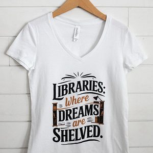 White t-shirt with a library-themed quote in black and brown text.