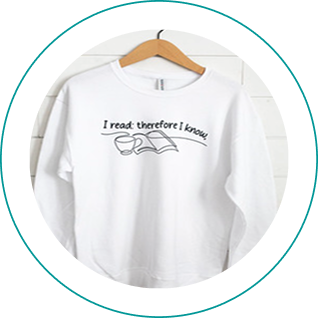 White t-shirt with a book and coffee cup graphic and the text 'I read, therefore I am'.