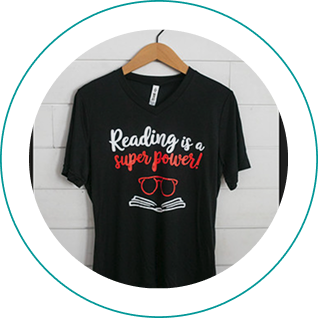Black t-shirt with "Reading is a super power!" text and open book graphic.