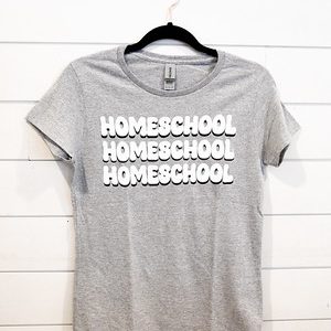 Gray T-shirt with repeated 'HOMESCHOOL' print in white.