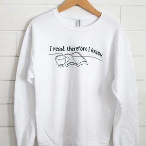 White sweatshirt with 'I read; therefore I am' text and book graphic.
