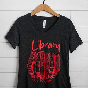 Black t-shirt with red 'Library' text and book design.