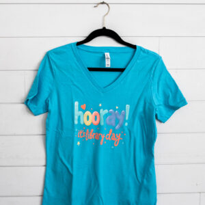 Blue T-shirt with library day text.