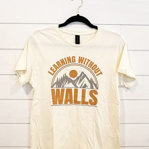 White T-shirt with 'Learning Without Walls' and mountain design in orange.