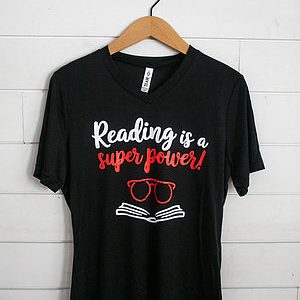 Black t-shirt with reading-themed text and graphics.